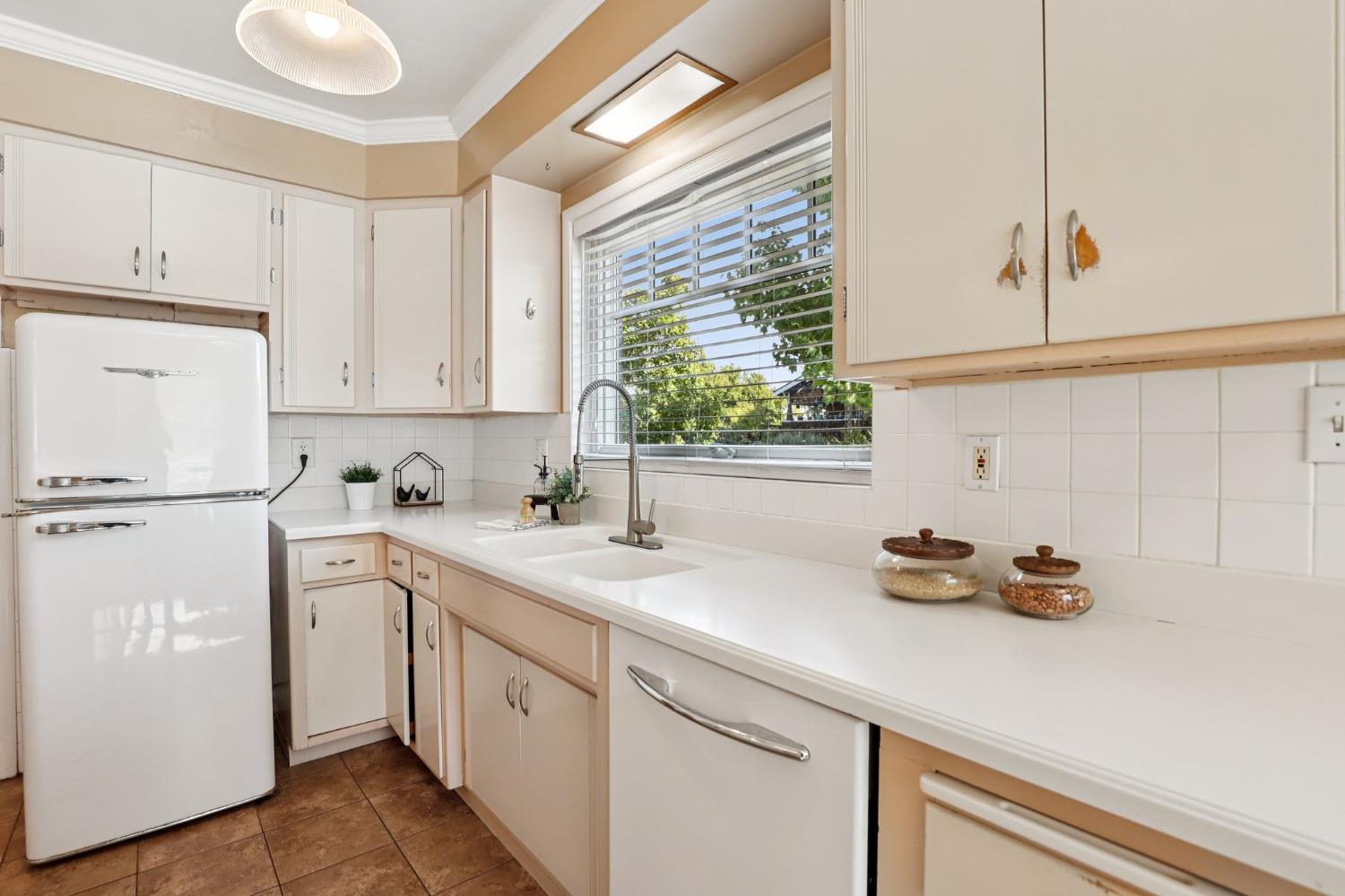 2200 2nd Avenue Sacramento, CA 95818 - Photo 25 of 69 a kitchen with white cabinets and white appliances