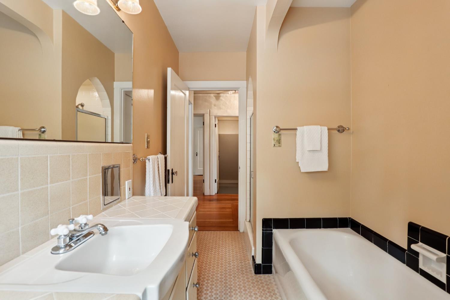 2200 2nd Avenue Sacramento, CA 95818 - Photo 35 of 69 a bathroom with a tub sink and mirror