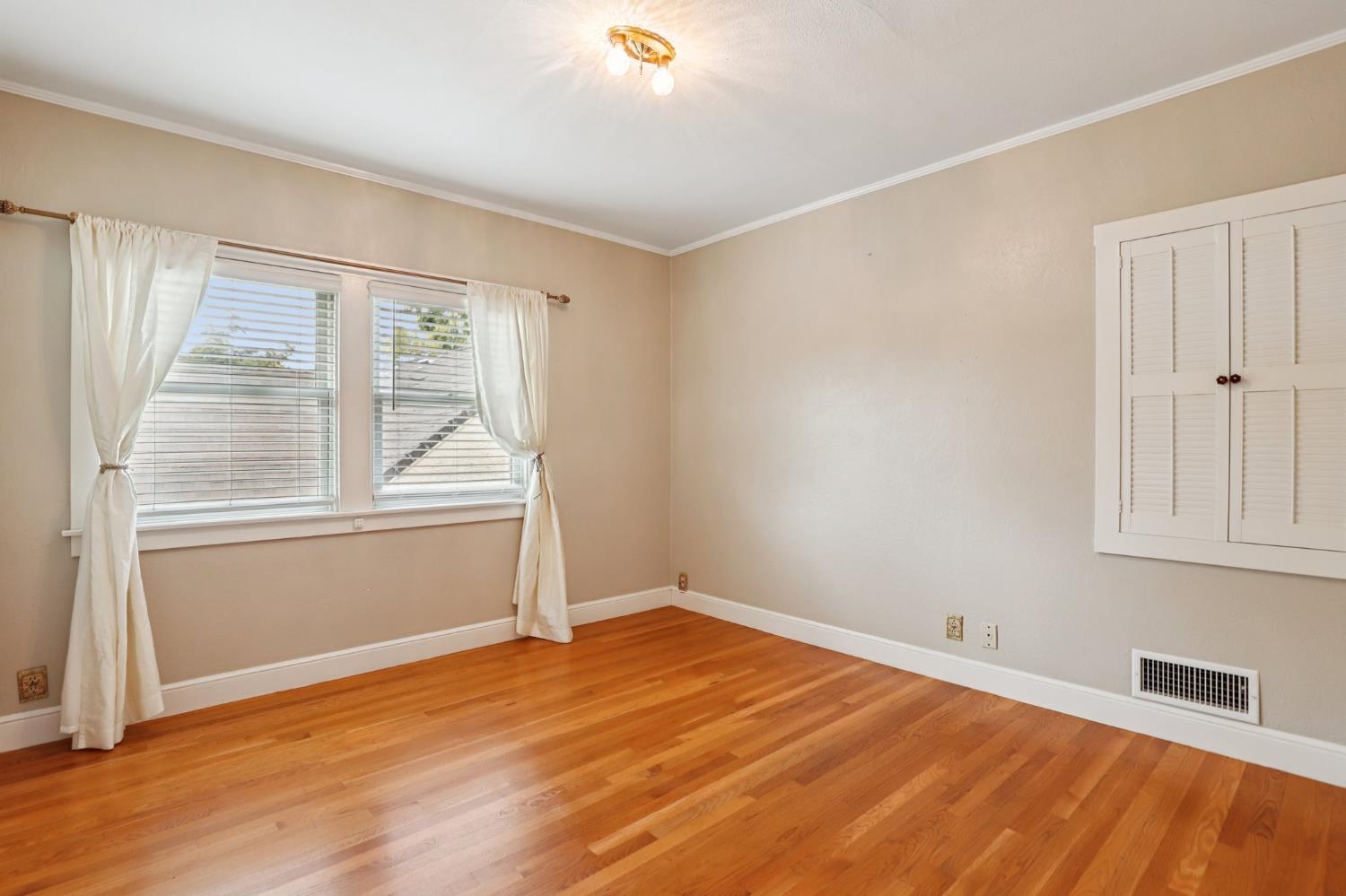 2200 2nd Avenue Sacramento, CA 95818 - Photo 46 of 69 an empty room with wooden floor and windows