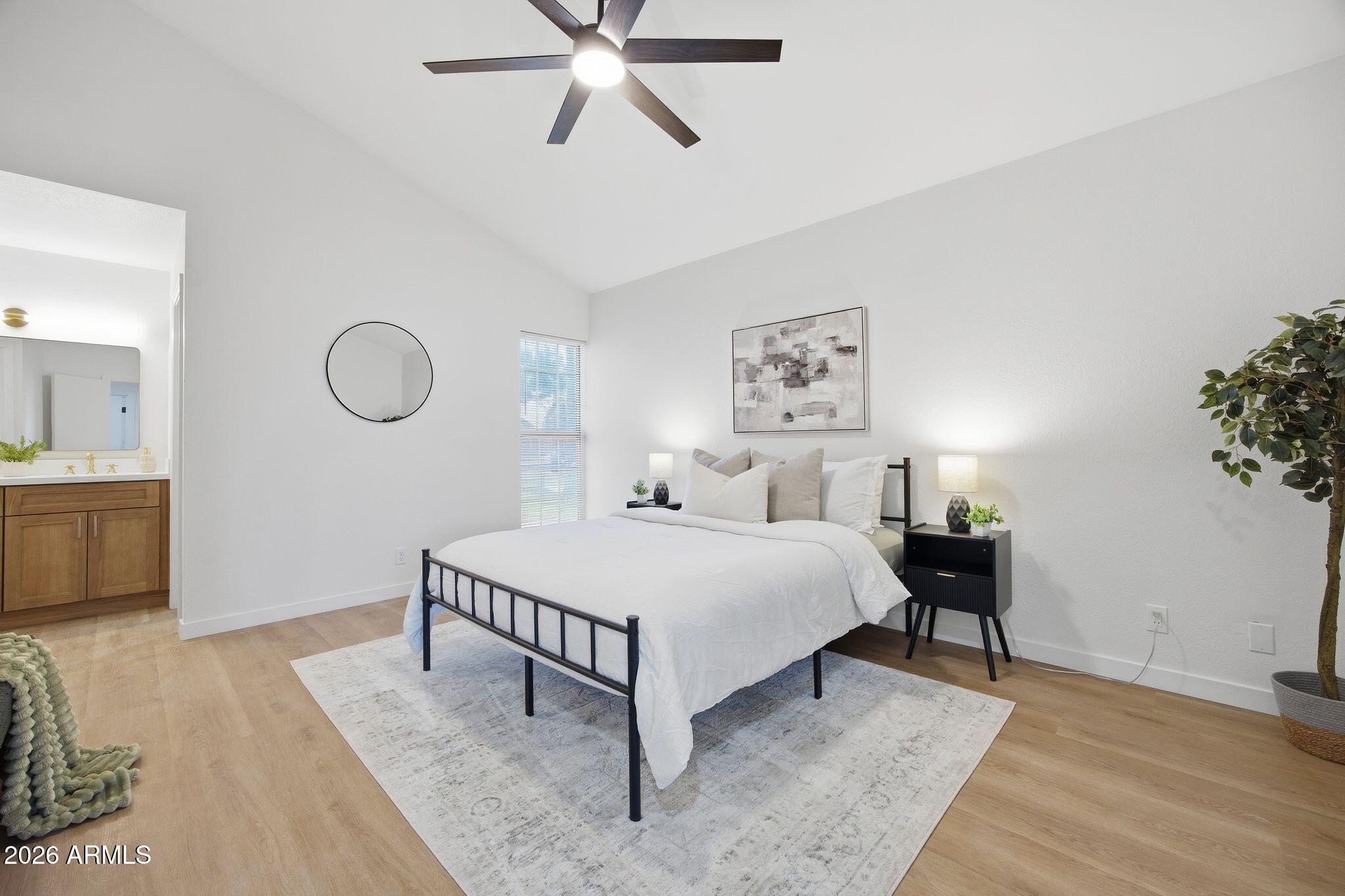 3134 East McKellips Road, Unit 69 Mesa, AZ 85213 - Photo 12 of 24 a bedroom with a bed and a chandelier