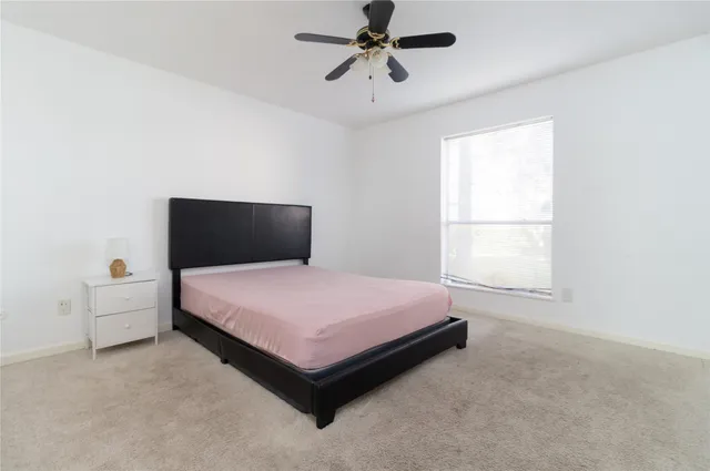 a bedroom with a bed and window