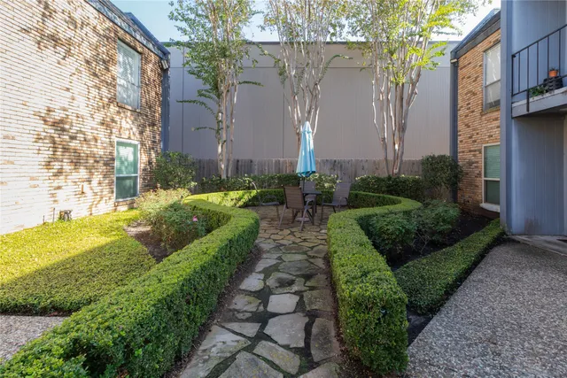 a view of a garden with a building in the background