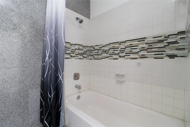 a bathroom with a bathtub and a shower