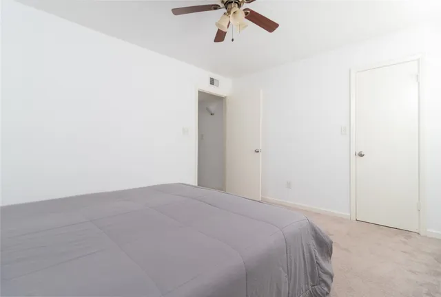 a view of a livingroom with a ceiling fan and window