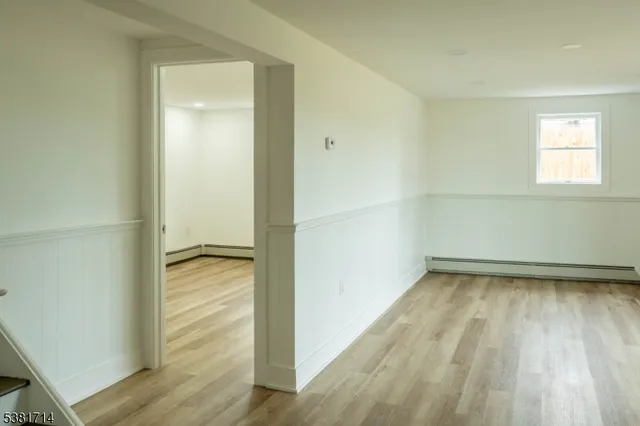 a view of a room with wooden floor and window