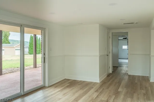 a view of wooden floor and windows in a room