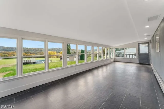 a view of an empty room with large windows