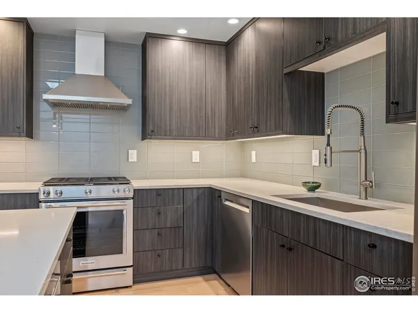 a kitchen with a sink cabinets and appliances