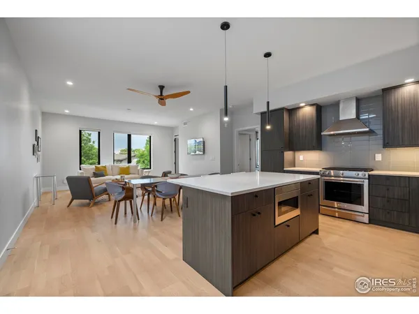 a kitchen with kitchen island a stove a counter top space and a dining table