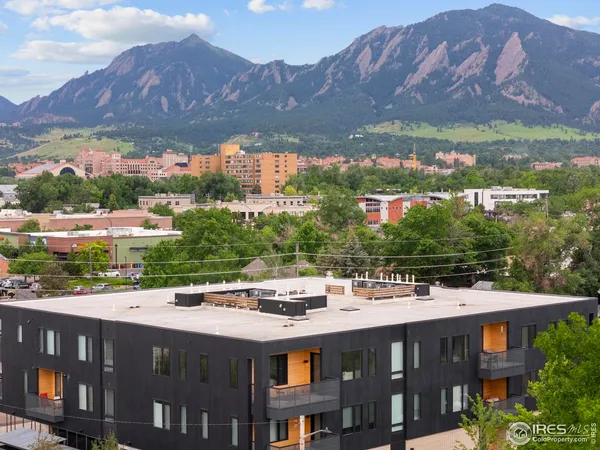 a view of a large building with a mountain in the background