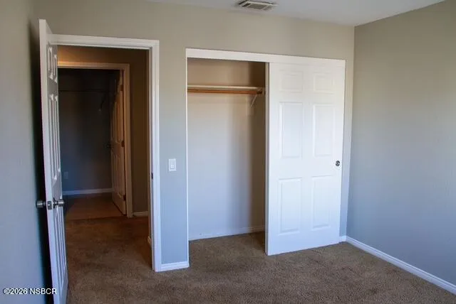 an empty room with closet area