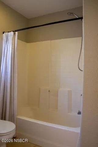 a bathroom with a shower and a toilet