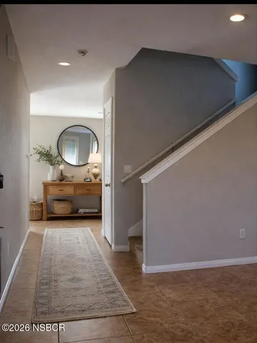 a view of a livingroom with furniture and an entryway