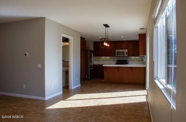 a view of a kitchen with a sink and cabinets