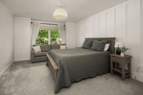 a bed sitting in a room next to a window