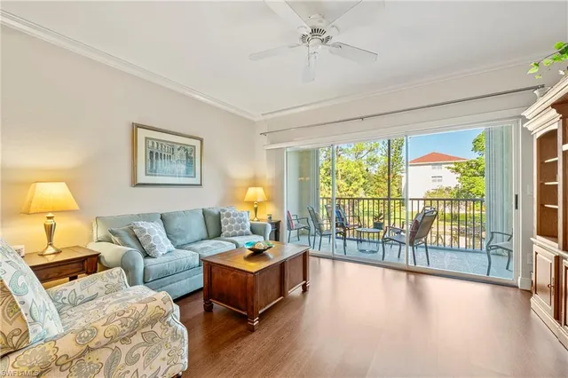 a living room with furniture and a large window with outer view