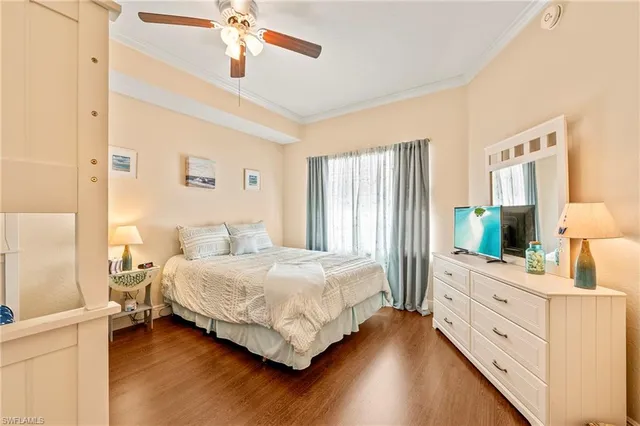 a bedroom with a bed and a dresser with mirror