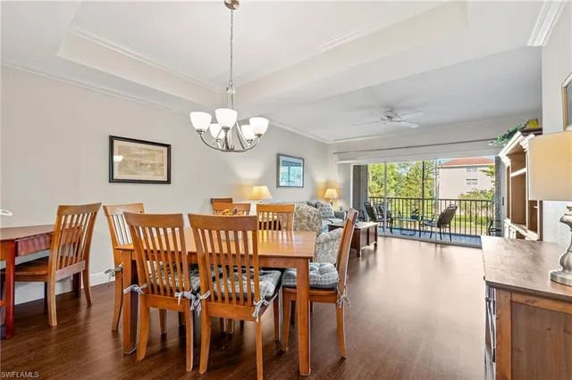 a view of a dining room with furniture wooden floor and chandelier