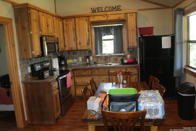 a kitchen with a table chairs and a refrigerator