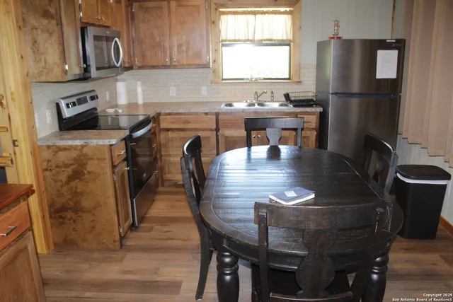 a dining table with chairs and wooden floor