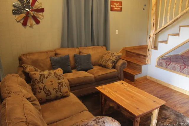 a living room with furniture and a painting on the wall
