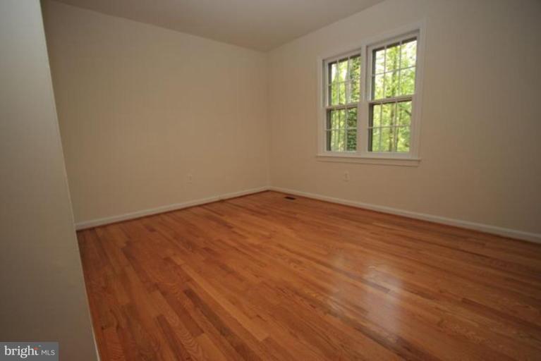 11322 Myrtle Lane Reston, VA 20191 - Photo 11 of 24 an empty room with wooden floor and windows