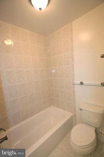 11322 Myrtle Lane Reston, VA 20191 - Photo 13 of 24 a bath tub sitting next to a white toilet