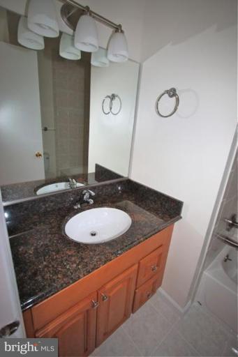 11322 Myrtle Lane Reston, VA 20191 - Photo 14 of 24 a bathroom with a granite countertop sink and a mirror