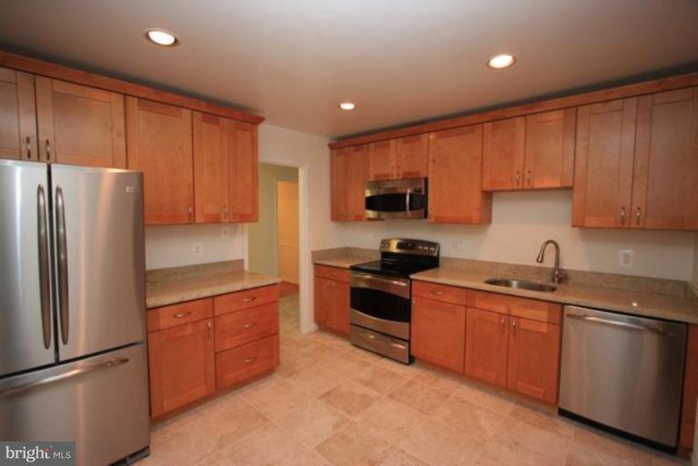 11322 Myrtle Lane Reston, VA 20191 - Photo 3 of 24 a kitchen with stainless steel appliances granite countertop a refrigerator stove top oven and sink