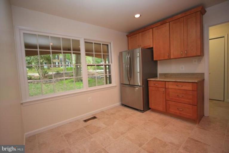 11322 Myrtle Lane Reston, VA 20191 - Photo 4 of 24 a kitchen with stainless steel appliances granite countertop a refrigerator and a sink