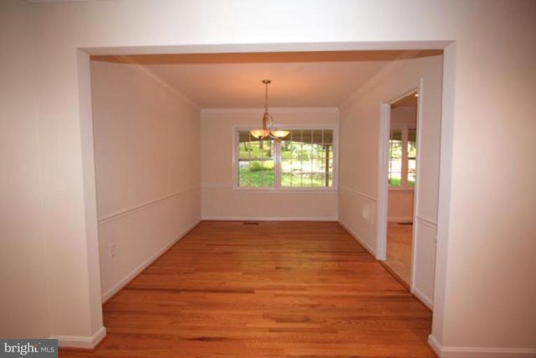 11322 Myrtle Lane Reston, VA 20191 - Photo 5 of 24 an empty room with wooden floor and windows
