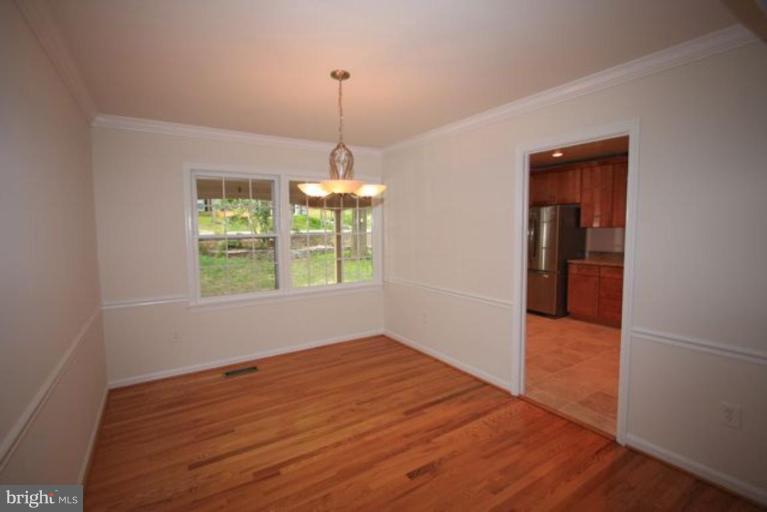 11322 Myrtle Lane Reston, VA 20191 - Photo 6 of 24 wooden floor in an empty room with a window