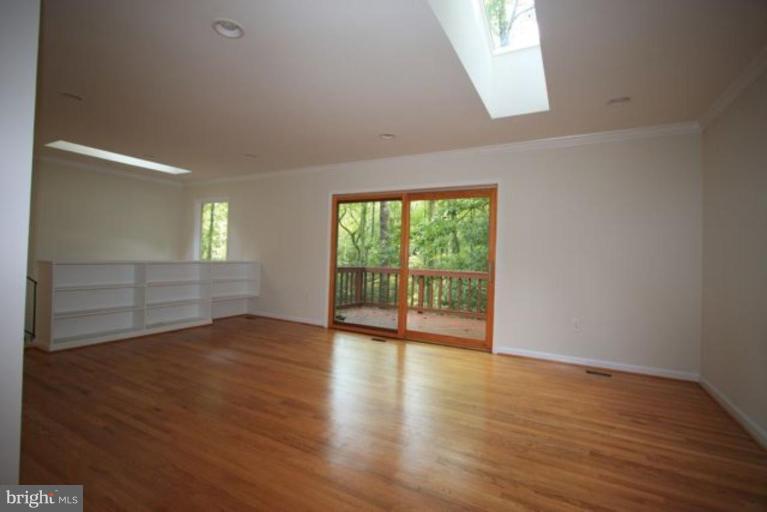 11322 Myrtle Lane Reston, VA 20191 - Photo 7 of 24 a view of an empty room with wooden floor and a window