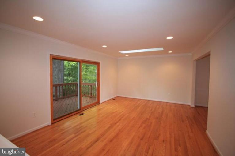 11322 Myrtle Lane Reston, VA 20191 - Photo 8 of 24 a view of an empty room with wooden floor and a window