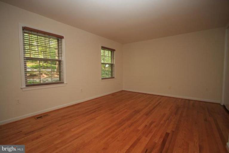 11322 Myrtle Lane Reston, VA 20191 - Photo 9 of 24 an empty room with wooden floor and windows