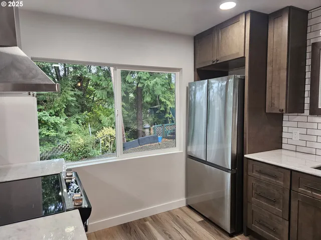 wooden floor in an empty room with a bathroom