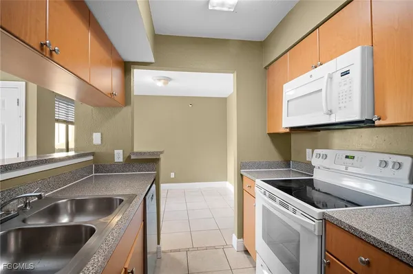 a kitchen that has a sink and a stove