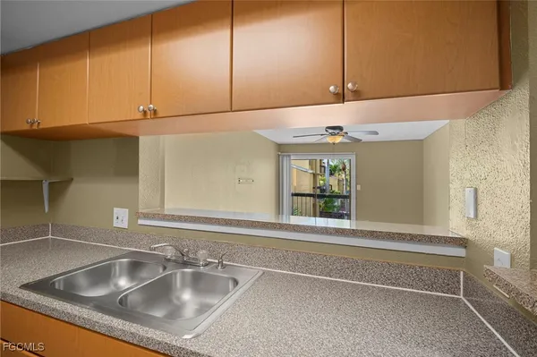 a kitchen with a sink and cabinets