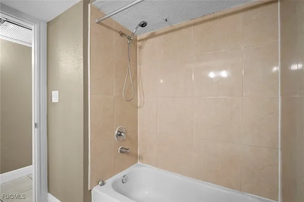 a bathroom with a tub and shower