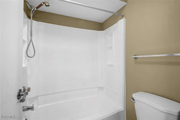 a bathroom with a bathtub and a toilet