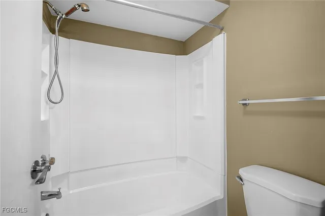 a bathroom with a bathtub and a toilet