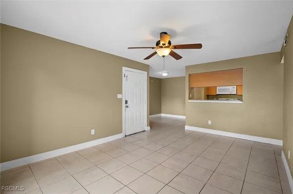 a view of a livingroom with an empty space and a window