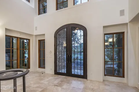 a view of kitchen with refrigerator and more cabinets