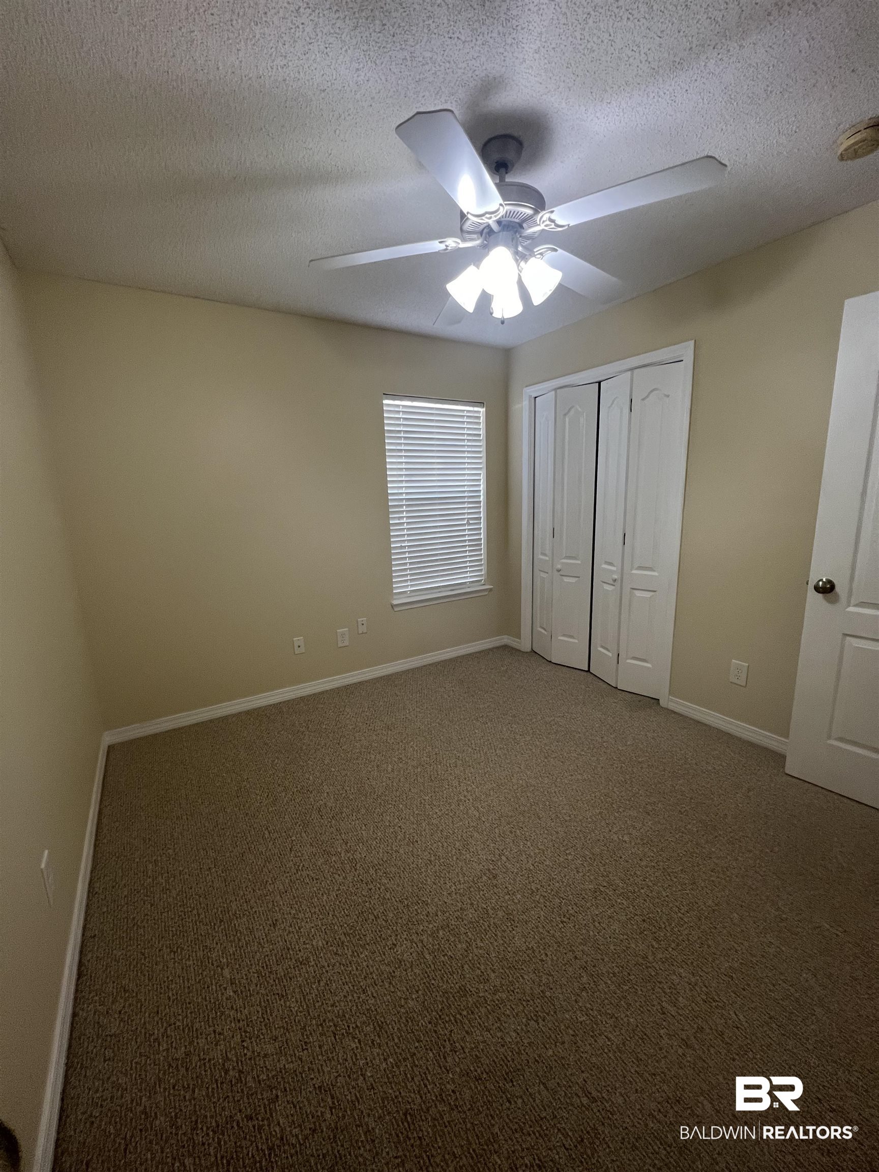 17793 Fancy Boulevard Foley, AL 36535 - Photo 26 of 34 Unfurnished bedroom with a textured ceiling, ceiling fan, and carpet