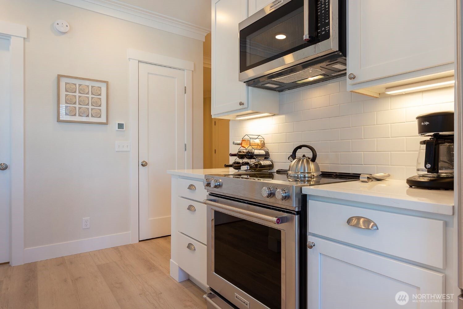 203 Market Street, Unit D Pacific Beach, WA 98571 - Photo 6 of 16 a kitchen with stainless steel appliances a stove a sink and a refrigerator