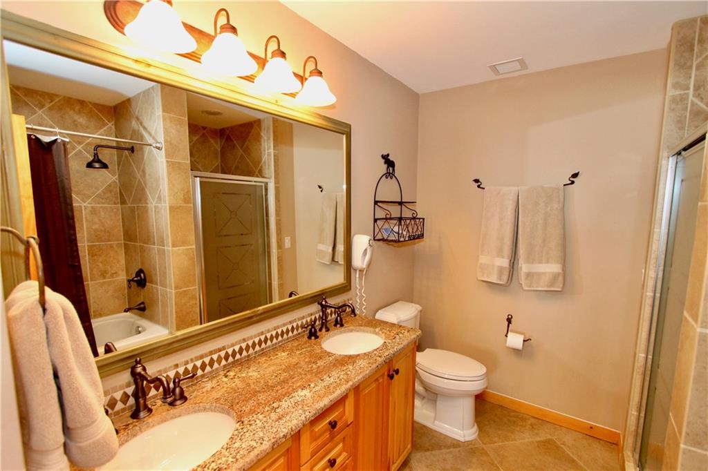 172 Copper Circle, Unit 210 Copper Mountain, CO 80443 - Photo 12 of 25 a bathroom with a granite countertop sink toilet and shower