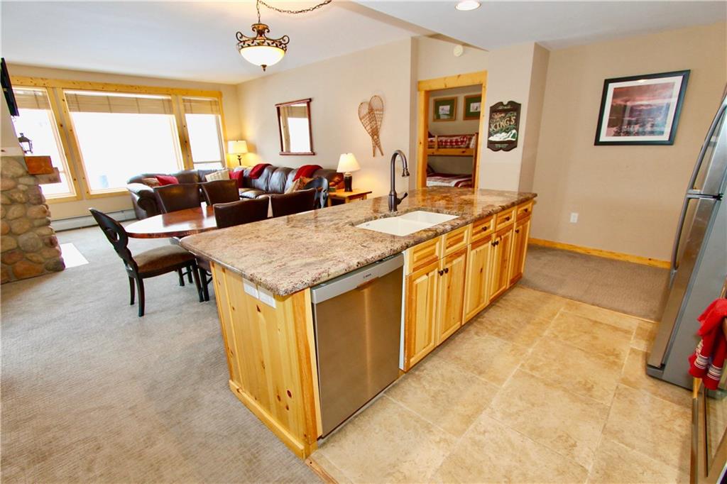 172 Copper Circle, Unit 210 Copper Mountain, CO 80443 - Photo 5 of 25 a open kitchen with stainless steel appliances granite countertop a stove and a refrigerator