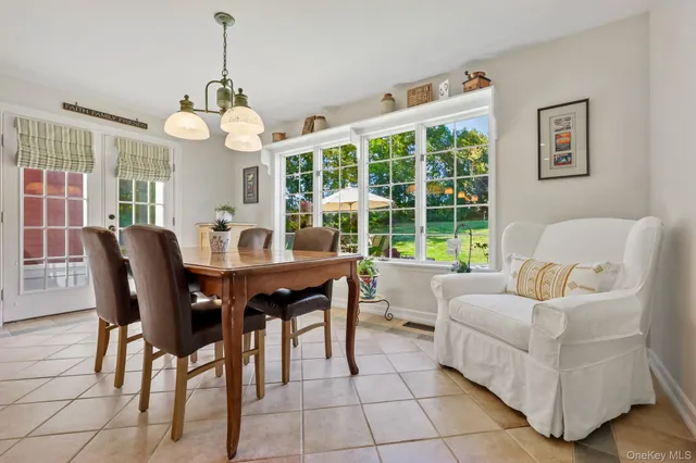 a view of a dining room with furniture wooden floor and chandelier