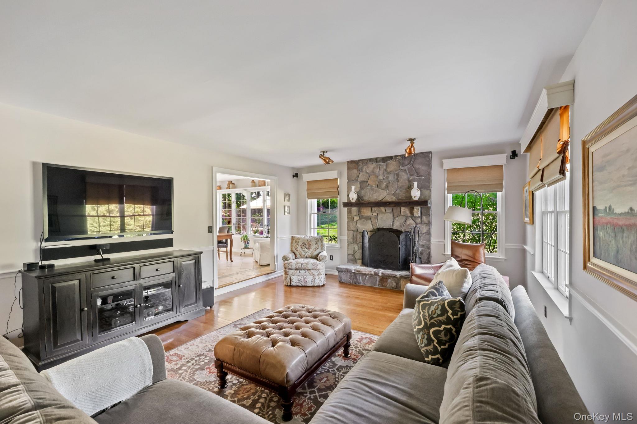 21 Adams Farm Road Katonah, NY 10536 - Photo 16 of 47 a living room with furniture a flat screen tv and a fireplace