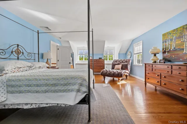 a bedroom with furniture and wooden floor